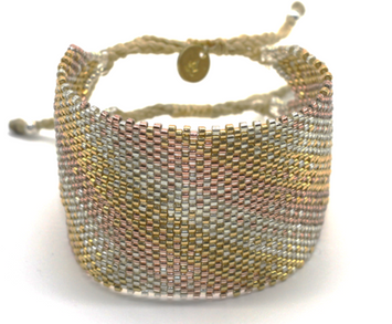 Myuki est une marque d'Amérique latine.  Manchette large tissée en perle de verre dans les ateliers.  motif : dégradé argent et doré  Embouts fermoir en argent  Hand made