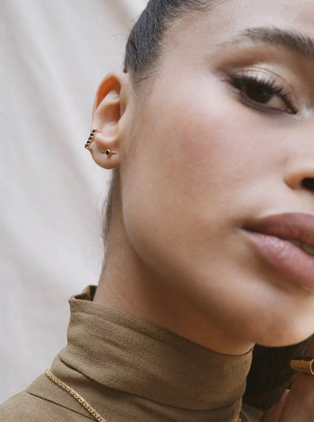 Gamme Blanche - Mono boucle en La Sensationnelle or 375 ( 9 carats ) & quartz moka Matériaux : Or 375 ( 9 carats )  Pierre : Cinq Quartz Moka - 2 mm - total de 0,54 cts  Dimensions de la boucle : 10 x 11 mm  Poids de la boucle : 1,74 g - une vraie plume sur l'oreille Dessinée en France, réalisée en Inde Fabrication : Jaipur, Inde